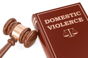 Domestic violence concept with gavel and book