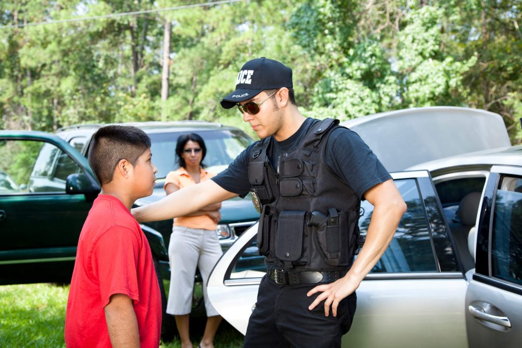 Policeman questioning witnesses during crime investigation