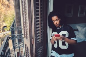 woman at home text messaging