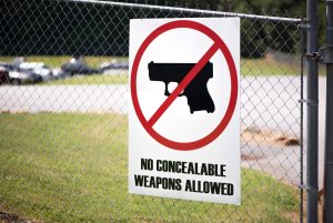 horizontal photograph of a sign showing a no gun zone area