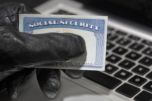 Thief holding a social security card